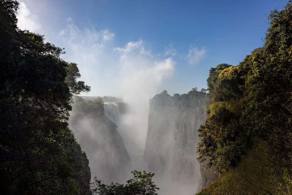 Victoria Falls in Zimbabwe, Africa, showcasing its majestic waterfalls and lush surrounding landscape.
