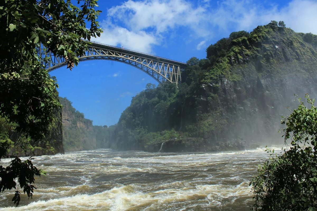A bridge over a rushing river at Victoria Falls, known for its bungee jumping attraction.