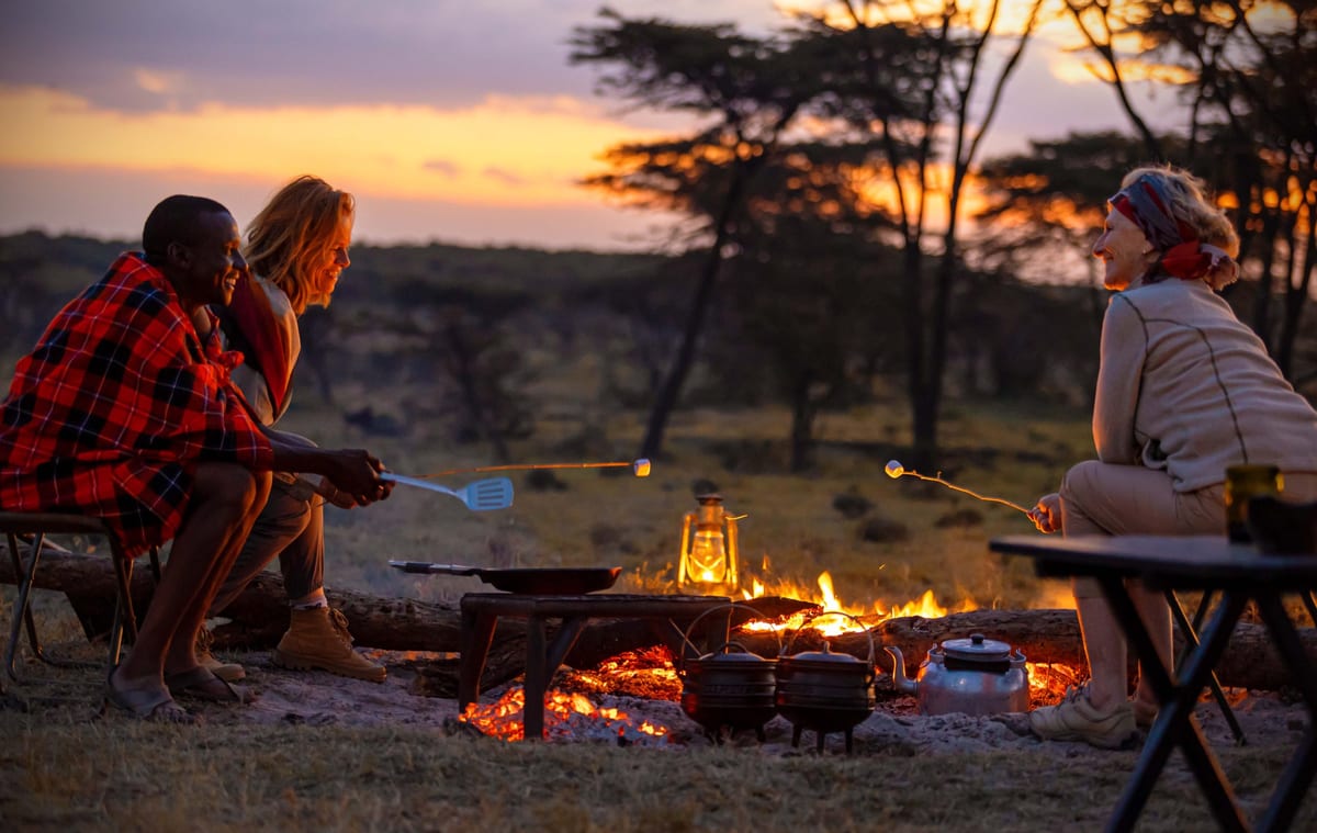 Family relaxing at safari lodge with wildlife backdrop