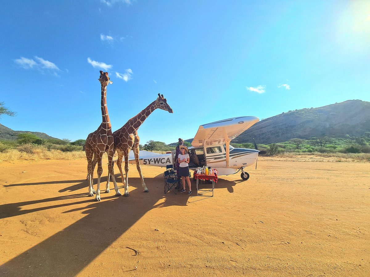 Family on safari game drive in Kenya landscape